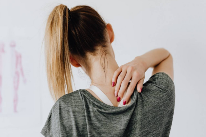 Woman with upper back pain. Concept for depiction of CBD's usages for pain relief.