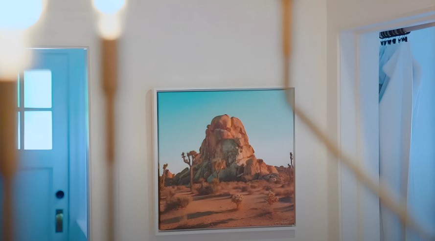 A desert landscape painting on the wall