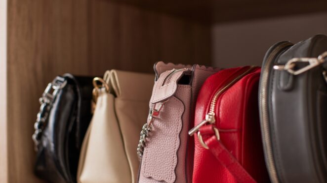 Leather handbags placed in a row on a clean, dry shelf