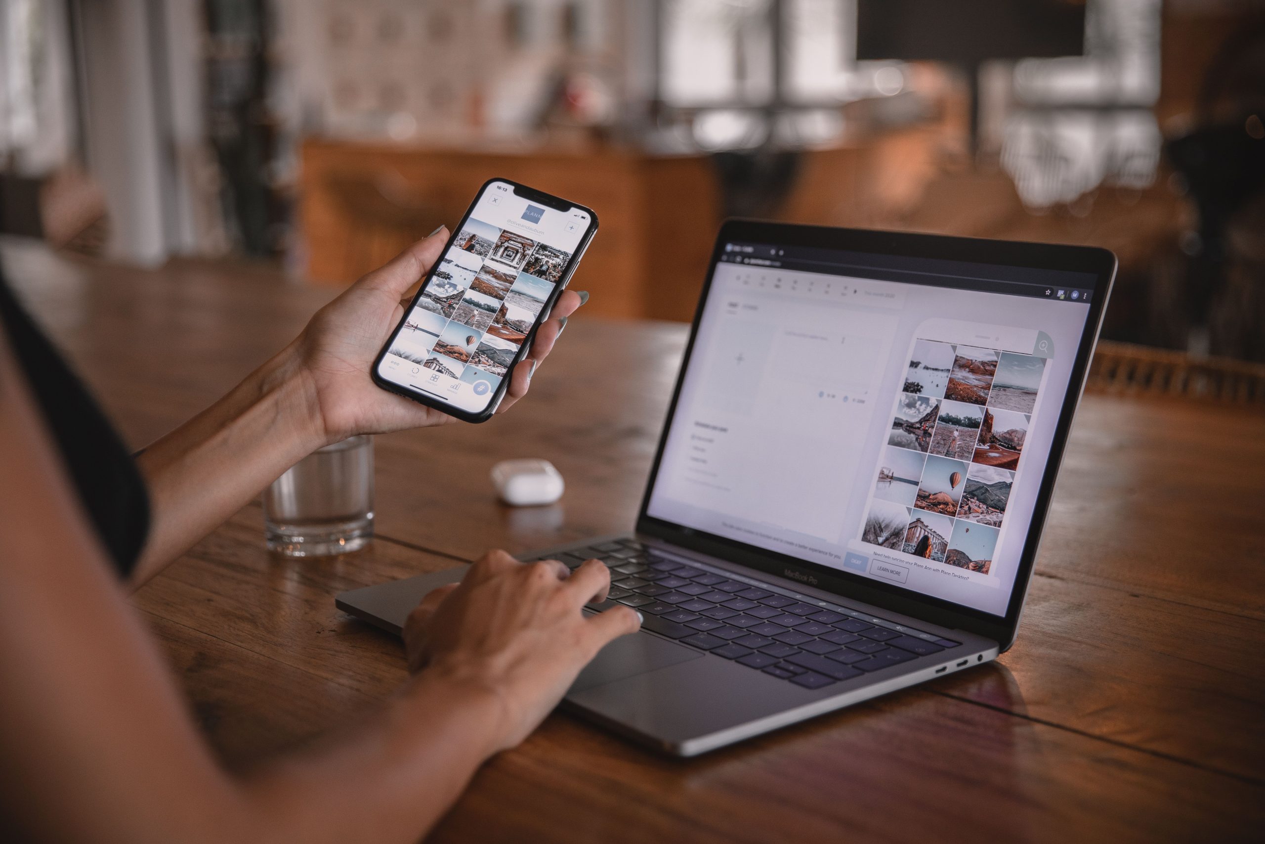 Woman editing social media content on her phone and laptop, applying AI image editing tools without a designer