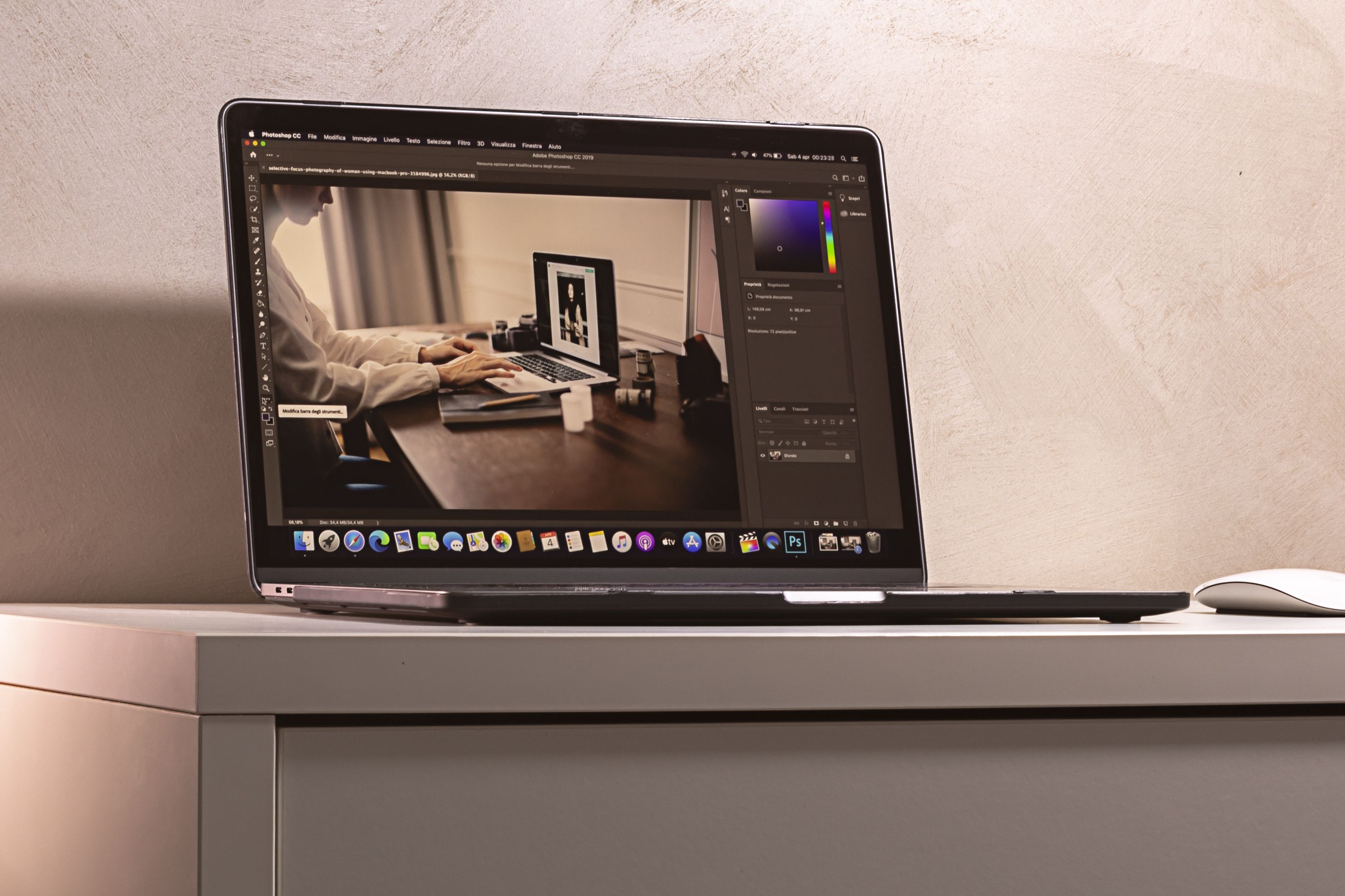 Laptop displaying a photo editing software interface on a clean modern desk