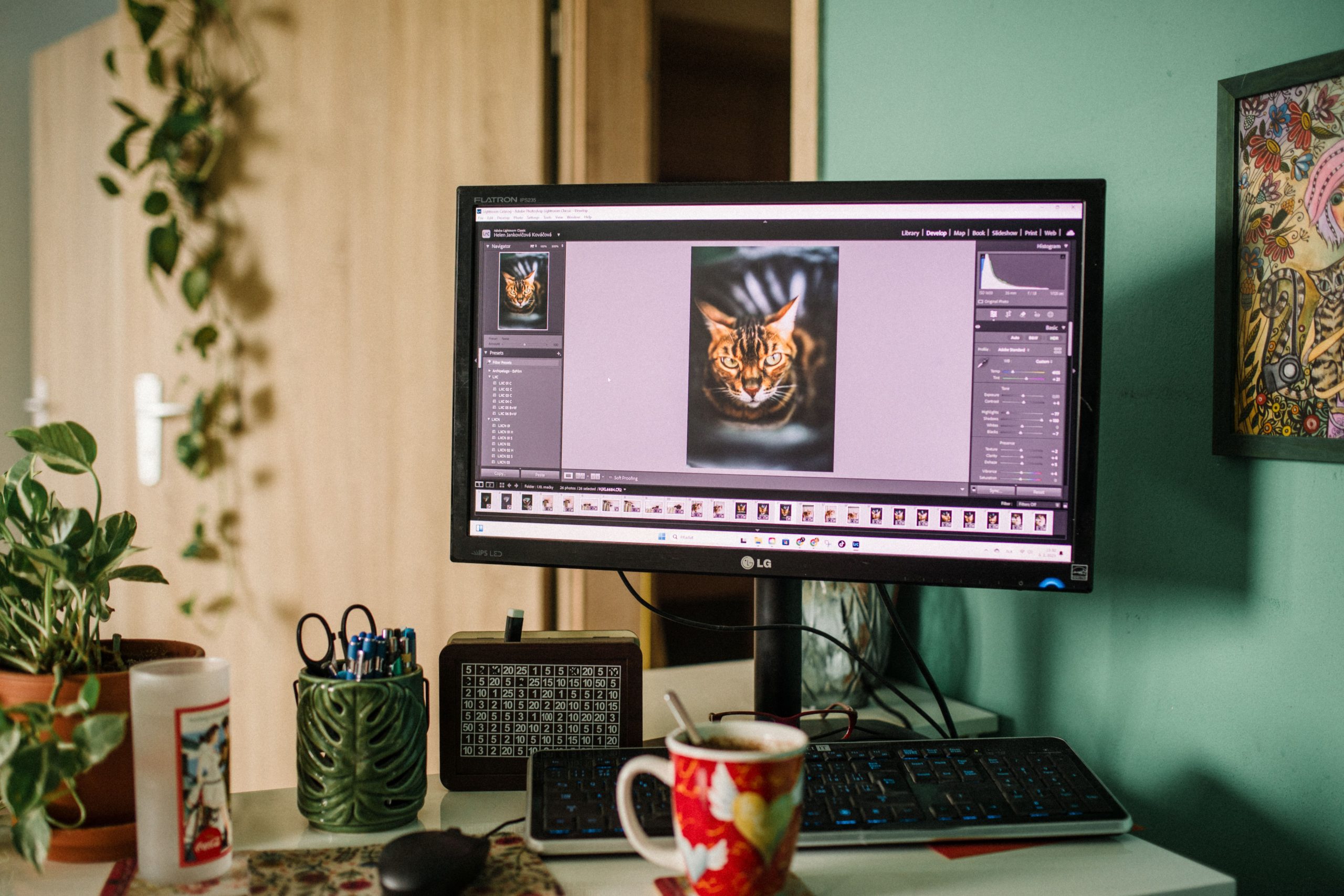 Home office desk with a monitor displaying AI photo editing software