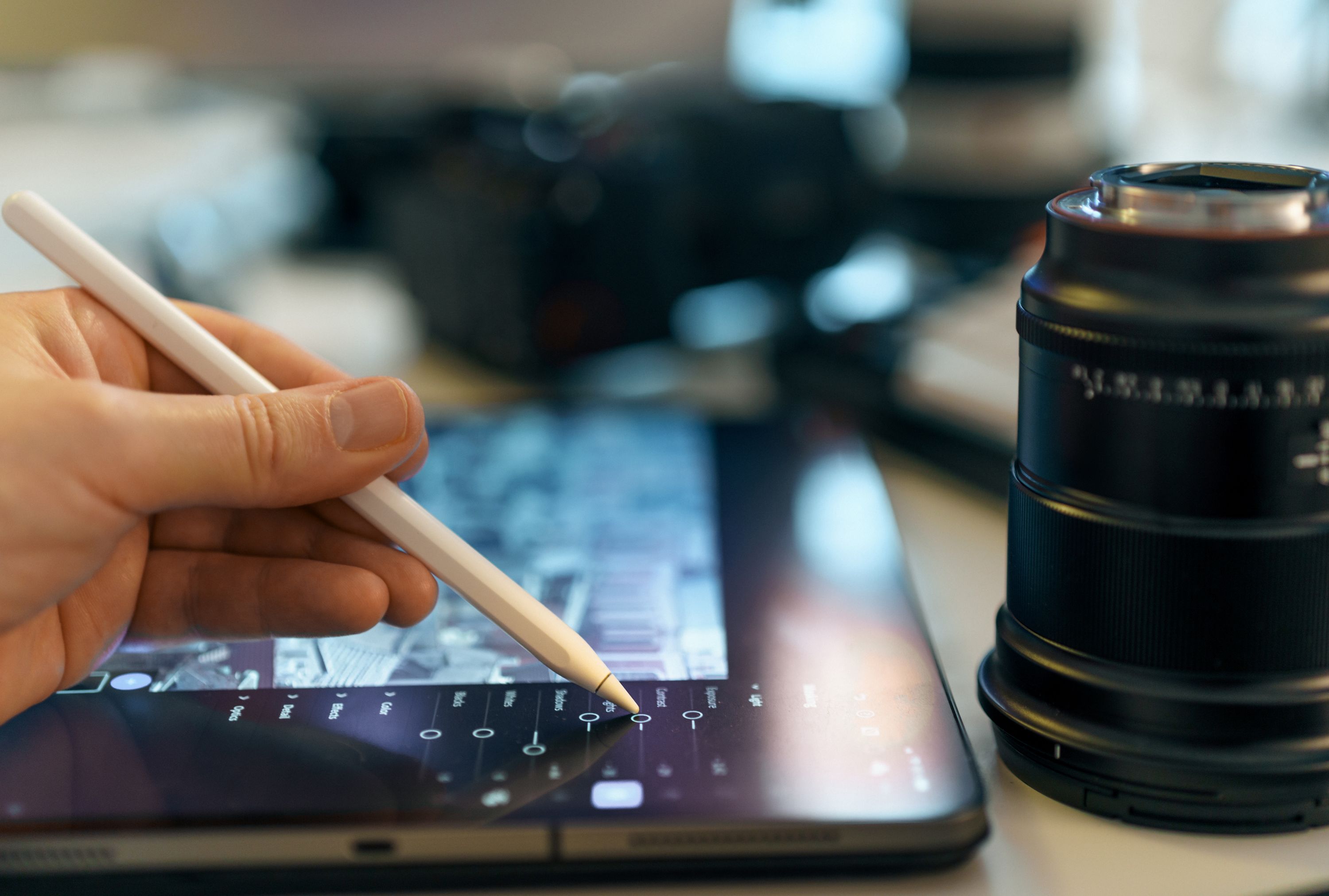 Digital artist using a stylus on a graphics tablet to edit images with AI tools