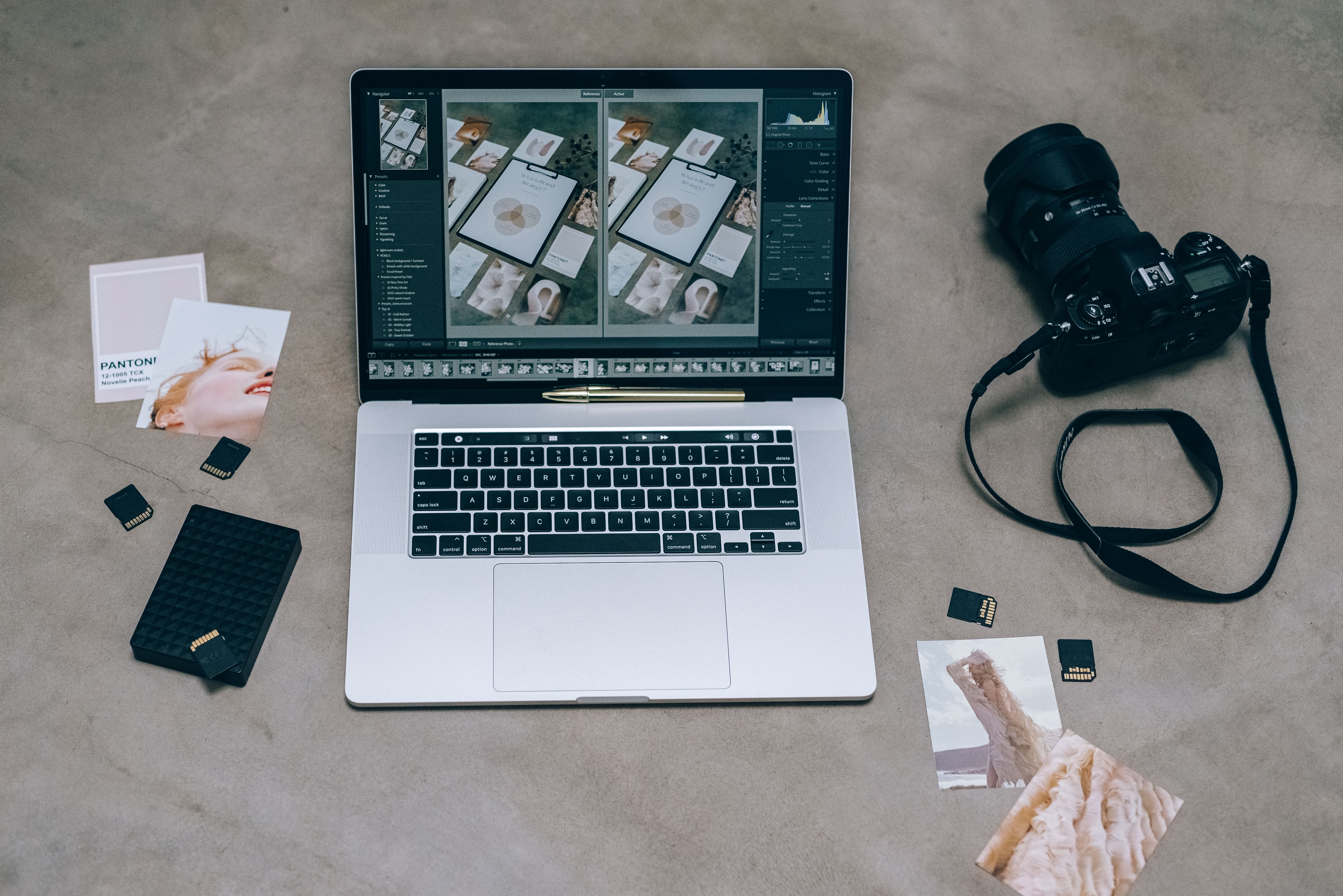 Top view of a laptop running photo editing software with a camera and memory cards, an AI image editing workflow